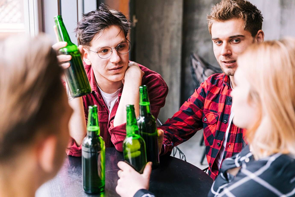 Intoxicated teen lying on the floor next to bottles
