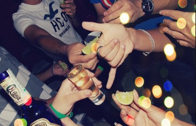 Teen boy stopping her mother from drinking too much